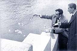 Klein throwing 20g of gold leaf into the Seine for Immaterial Sensitivity Zone 5, 26 January 1962. The buyer is burning his cheque.