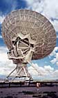 Hartman next to radio telescope at Very Large Array, New Mexico